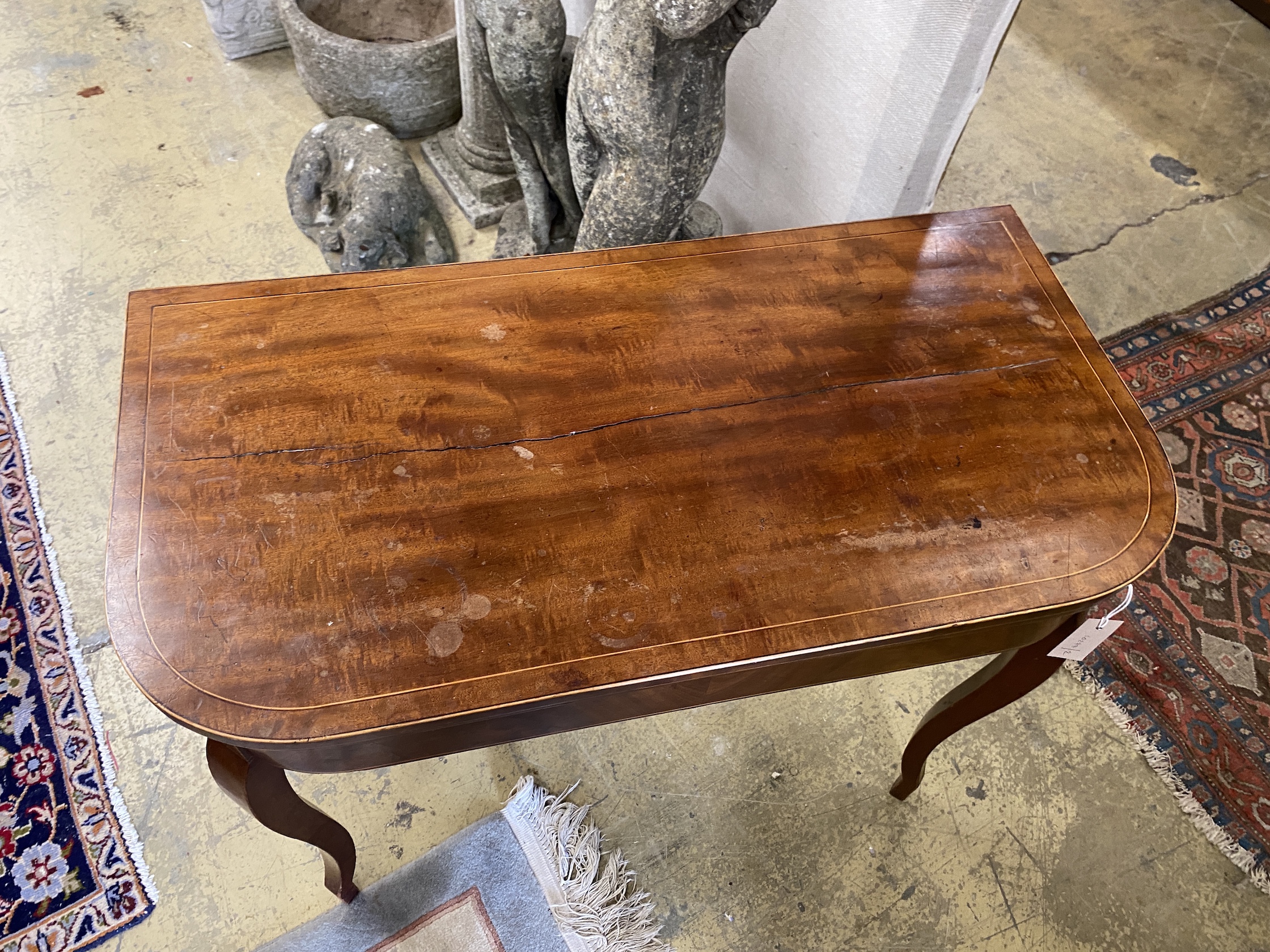 A George III mahogany D shaped folding card table, width 89cm, depth 45cm, height 75cm